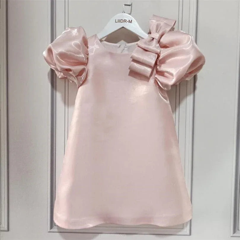 Princess pink party dress for little girls with puff sleeves and large bow detail size medium