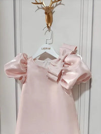 princess pink party dress for little girls with puff sleeves and large bow detail