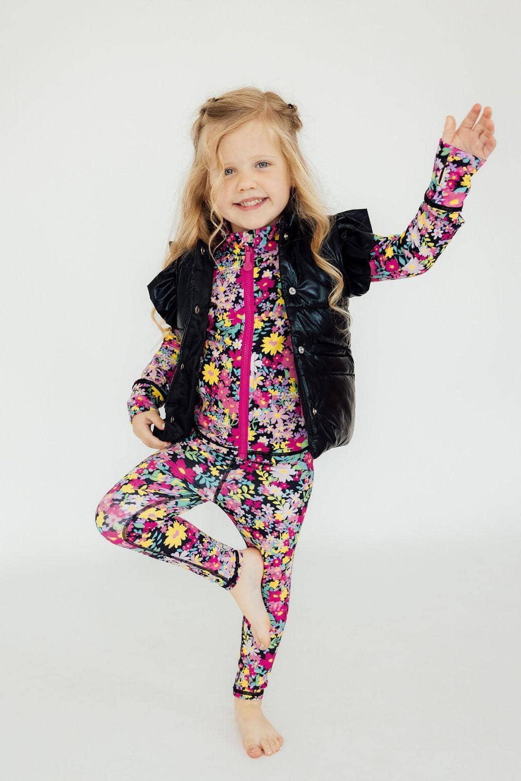 Girls black puffer vest with ruffle sleeves for kids over floral long sleeve outfit
