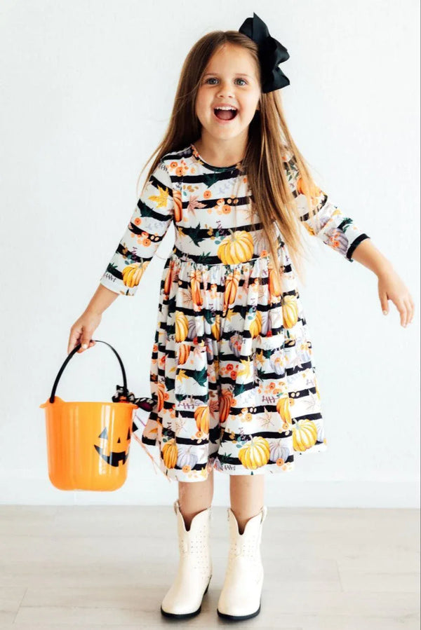 Girls pumpkin print twirl dress with 3/4 sleeves in black and white stripes with orange pumpkins