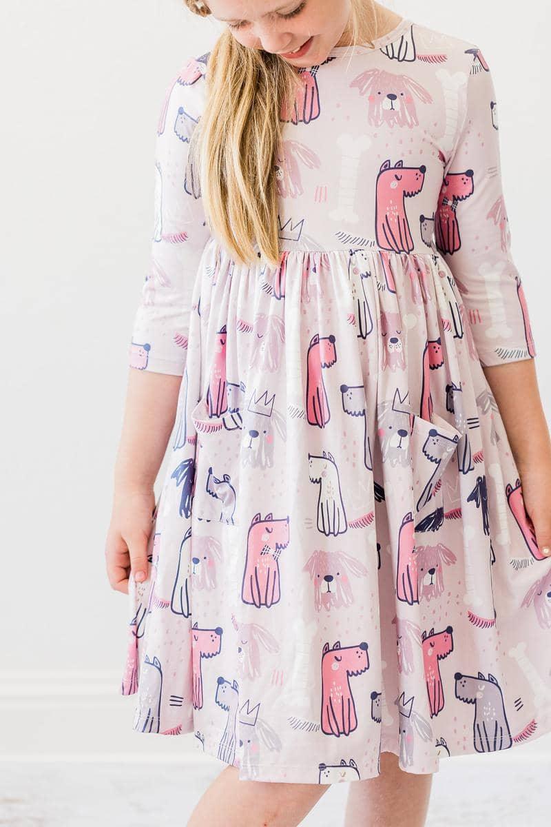 young girl wearing pink Mila Rose puppy party dress for girls twirl pocket dress 