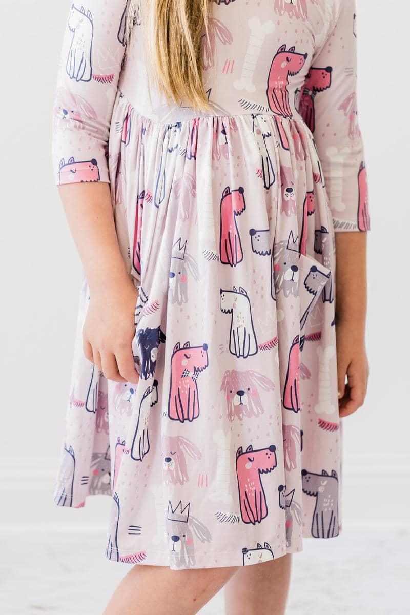 Young girl wearing Mila & Rose puppy party dress for girls twirl pocket dress with  in pastel colors