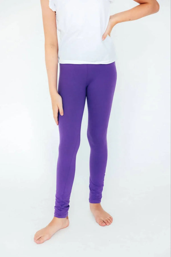 Girl wearing Mila and Rose purple leggings for girls standing barefoot with hand on hip