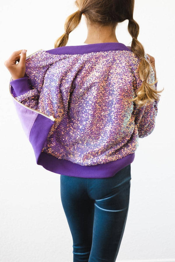 girl wearing purple sequin jacket for kids showing back with pigtails and blue leggings