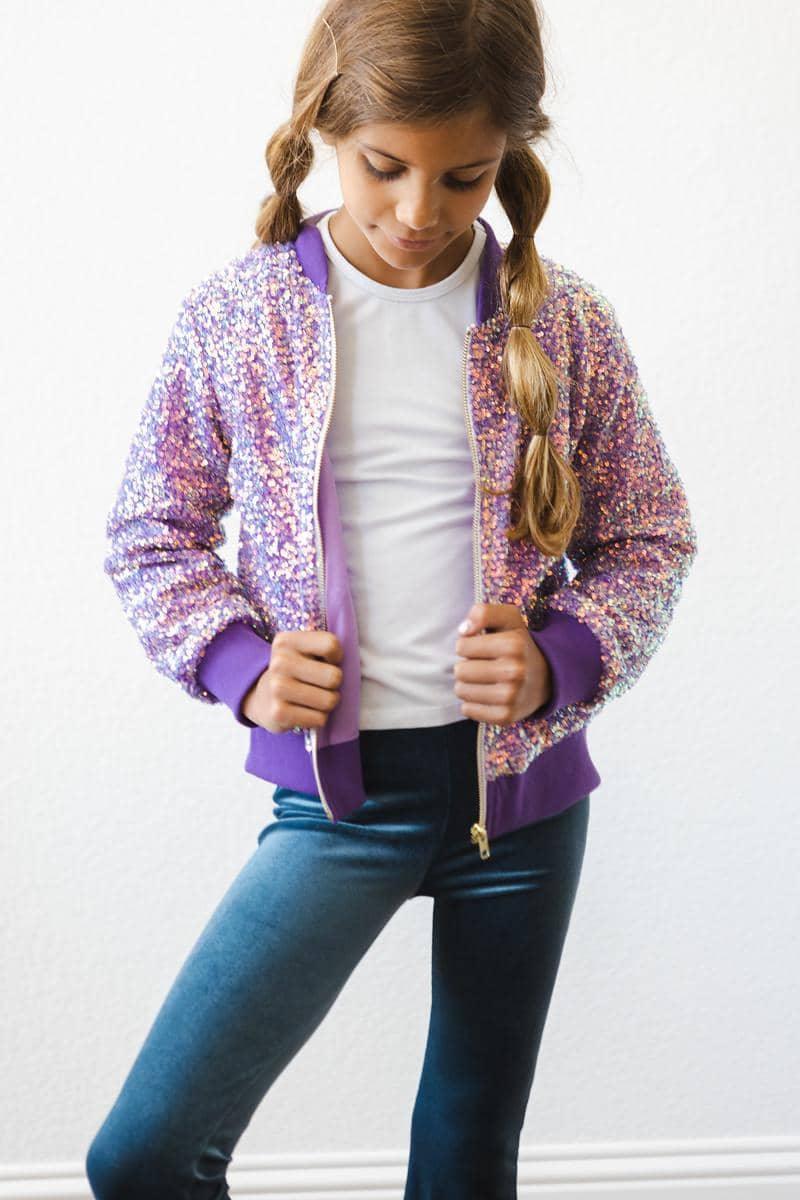 girl wearing purple sequin jacket for kids standing and looking down