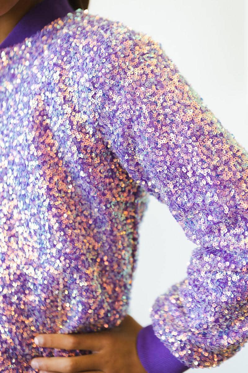 child wearing purple sequin jacket for kids with hand on hip in confident pose