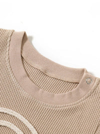 beige baby romper with textured knit fabric and snap button on shoulder for easy dressing rainbow baby romper