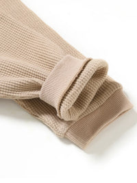Beige waffle knit baby romper sleeve detail with ribbed cuffs for infants rainbow baby romper