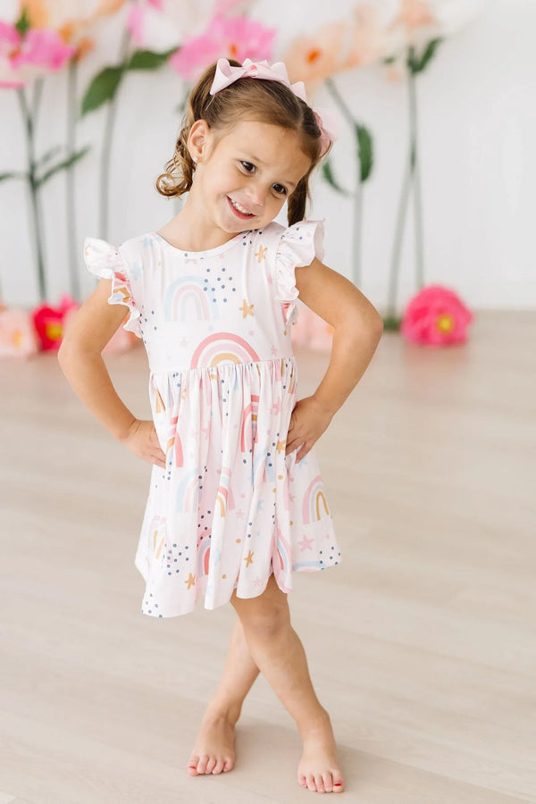 Girls white twirl dress with rainbow flutter sleeves and playful rainbow print for toddlers