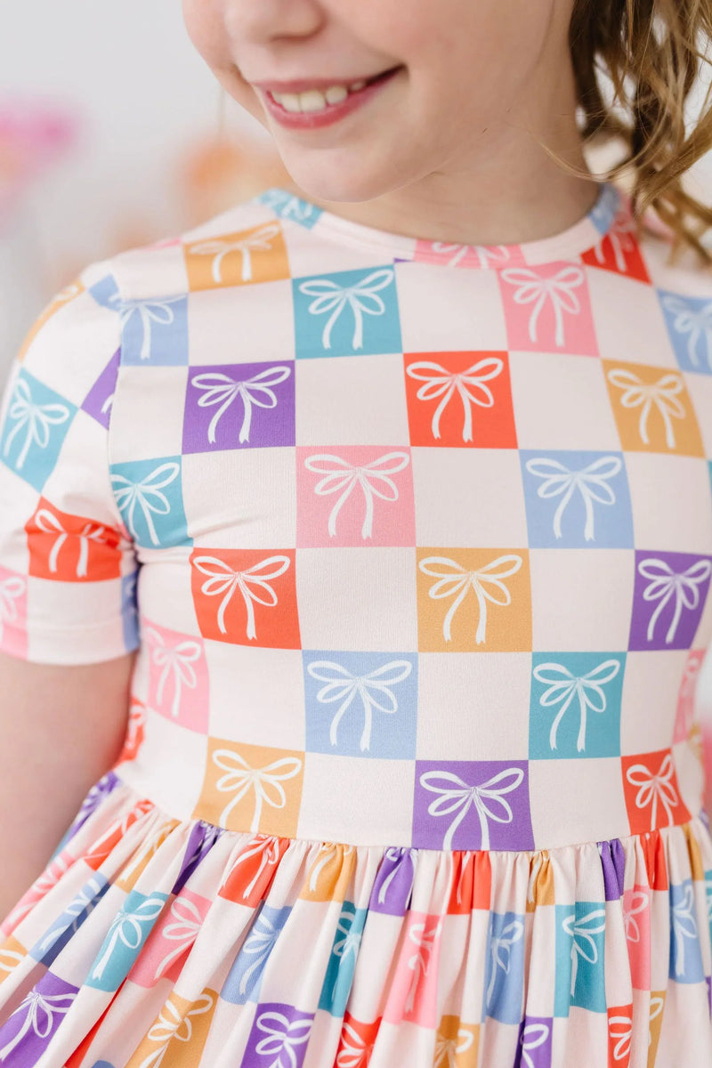 Girls rainbow twirl dress for girls by Mila & Rose with colorful bow print and short sleeves