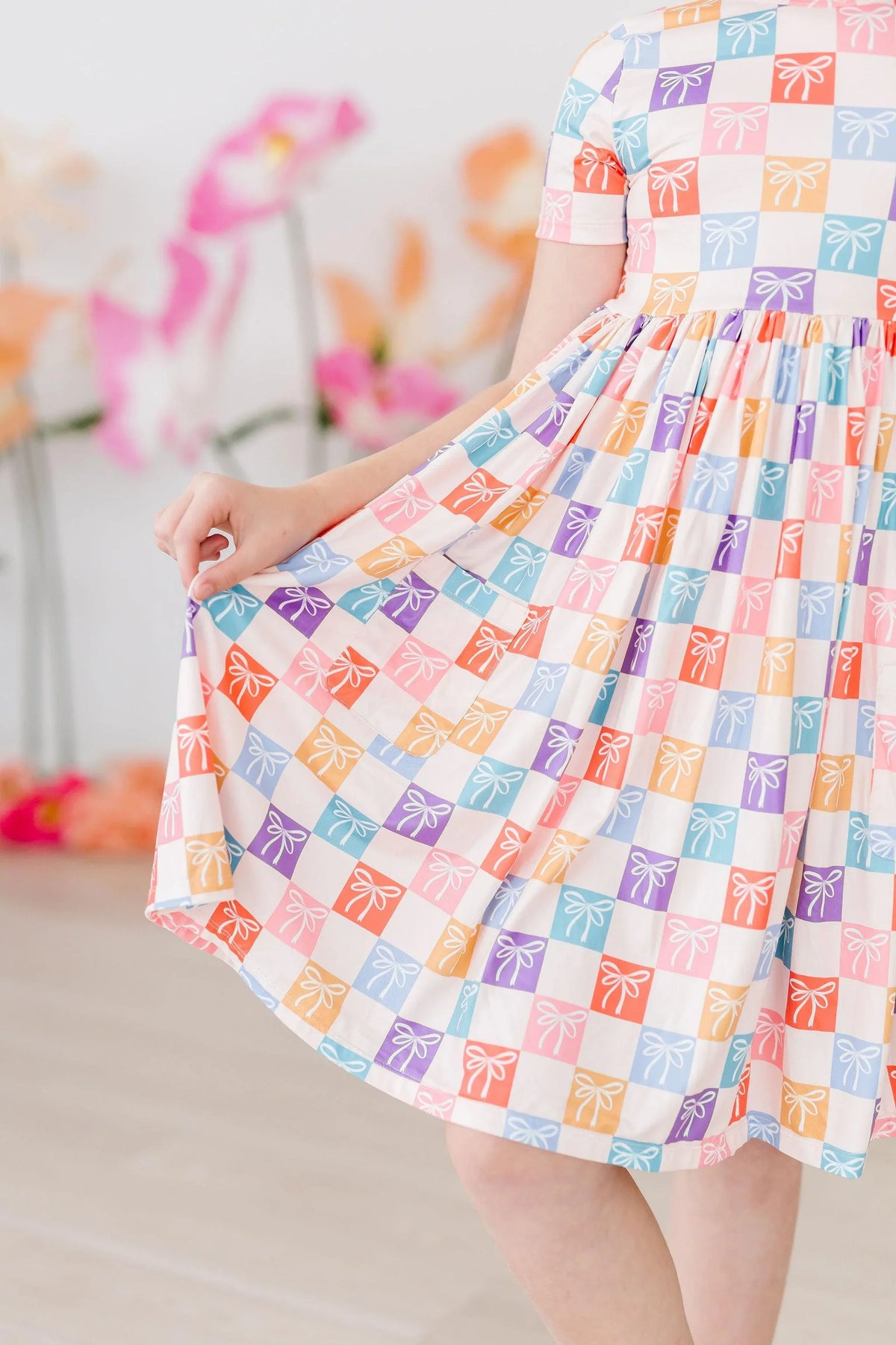 Girls rainbow twirl dress for girls with short sleeves and colorful bow pattern by Mila Rose