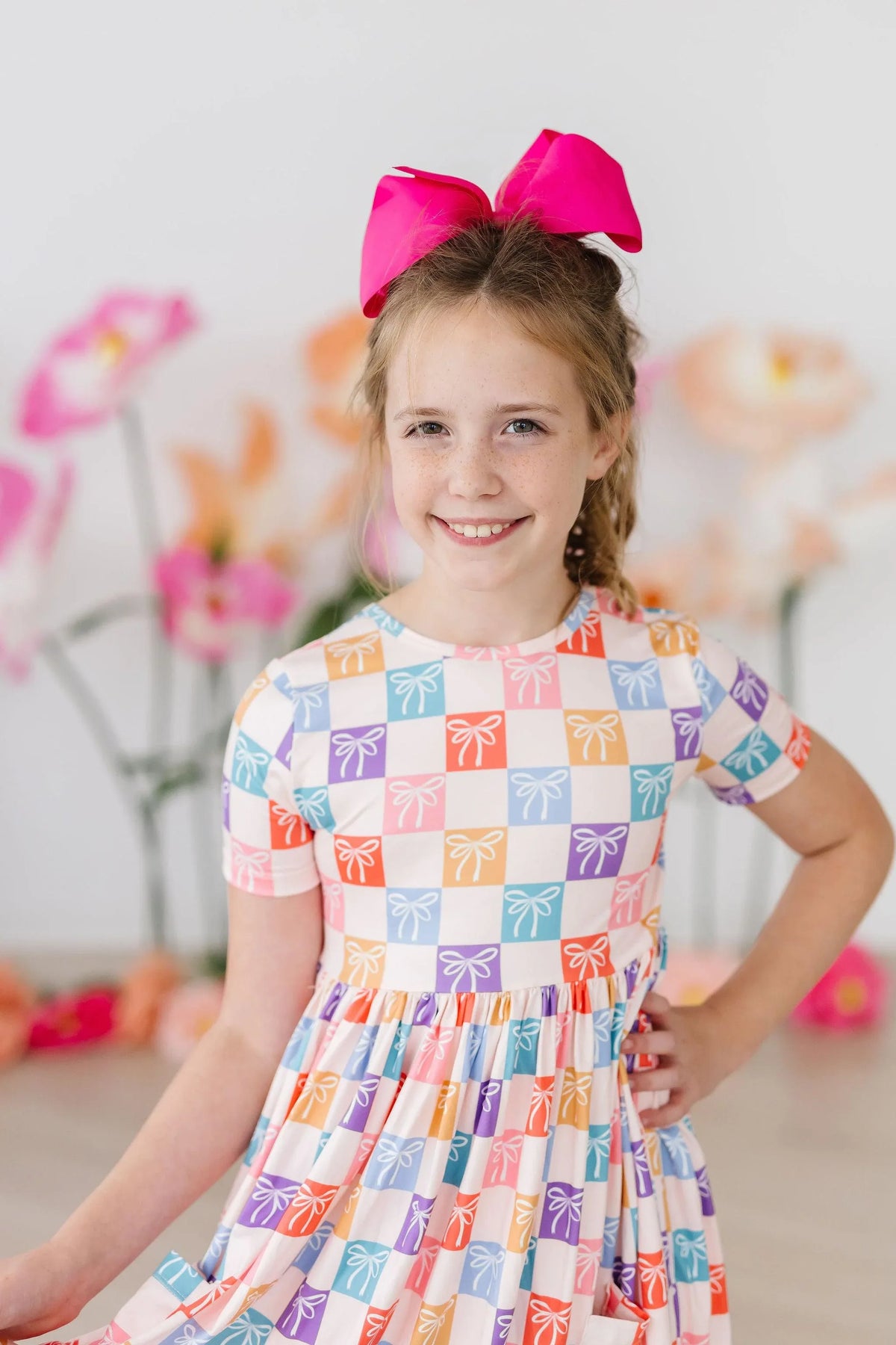Girls short sleeve rainbow twirl dress for girls with colorful bow pattern and pink hair bow