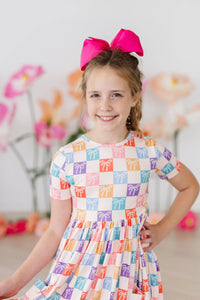 Girls short sleeve rainbow twirl dress for girls with colorful bow pattern and pink hair bow