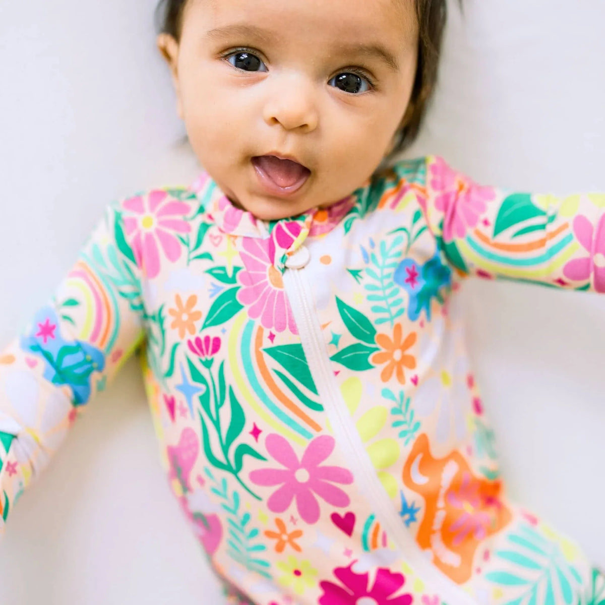 Raising Mama Rainbow Daisy Baby Footie - Colorful Floral Baby Romper - The Palm Beach Baby