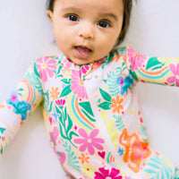 Raising Mama Rainbow Daisy Baby Footie - Colorful Floral Baby Romper - The Palm Beach Baby