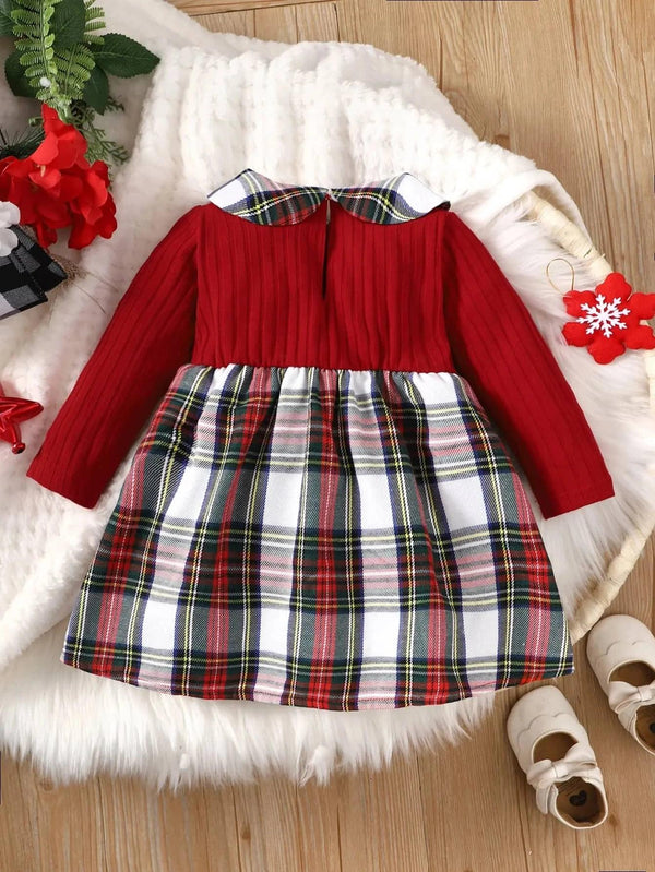 baby dress with red ribbed top and red plaid girls dress skirt lying flat on white blanket