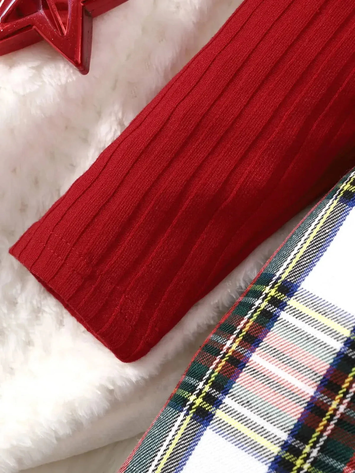 close-up of red sleeve and red plaid girls dress fabric for toddlers