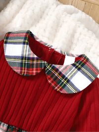 Close-up of red plaid girls dress collar with pleated red fabric for toddlers