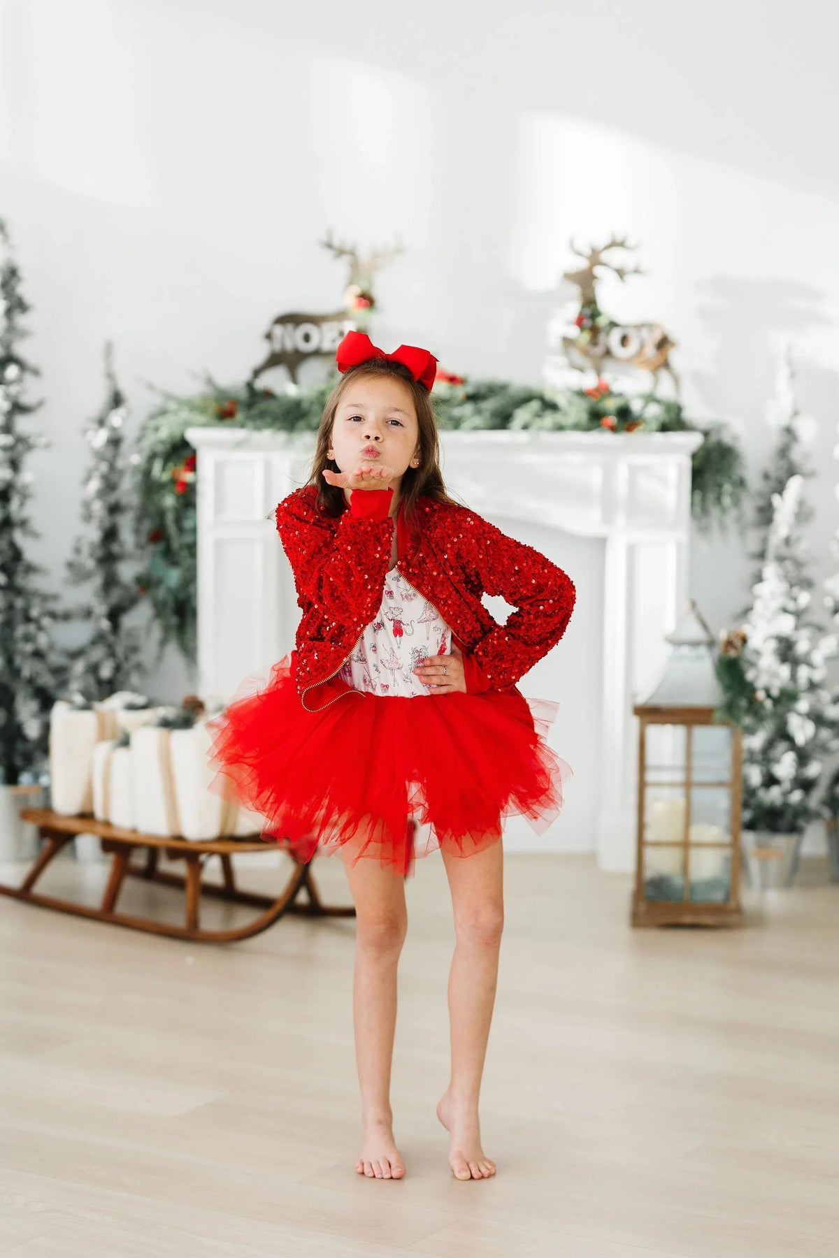 Girls red sequin jacket for girls with long sleeves worn by young girl with red tutu and bow