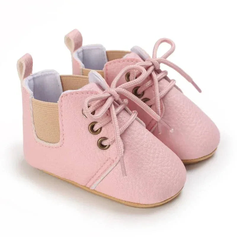 Pair of pink retro baby lace-up shoes for infants with soft soles and side elastic panels