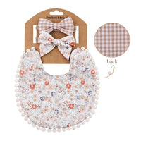 floral and brown plaid reversible baby bib and headband set for infants on packaging