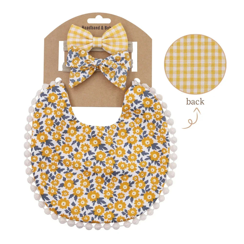 Yellow and white floral reversible baby bib and headband set for infants with pom pom trim and checkered pattern