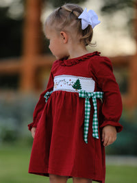 Red Christmas smocked girls dress with festive tree embroidery and green plaid bow sash.