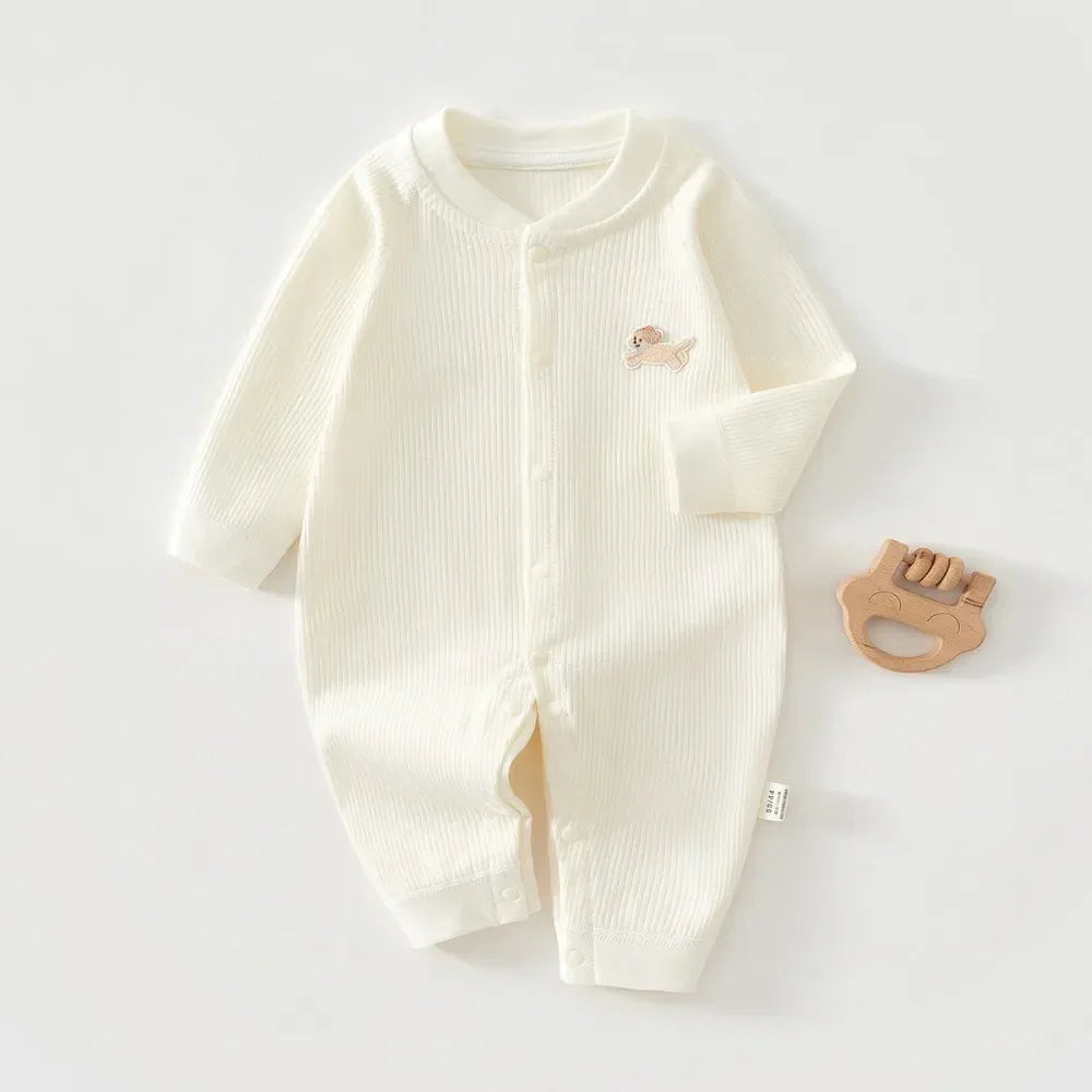 Cream white ribbed knit baby romper made of soft cotton with long sleeves and small embroidered animal design