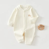 Cream white ribbed knit baby romper made of soft cotton with long sleeves and small embroidered animal design