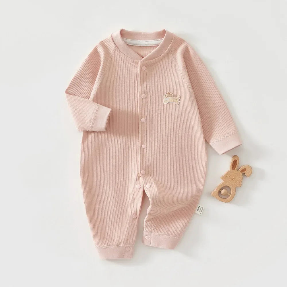 Soft pink ribbed knit baby romper made from breathable cotton with snap buttons and cute dog patch