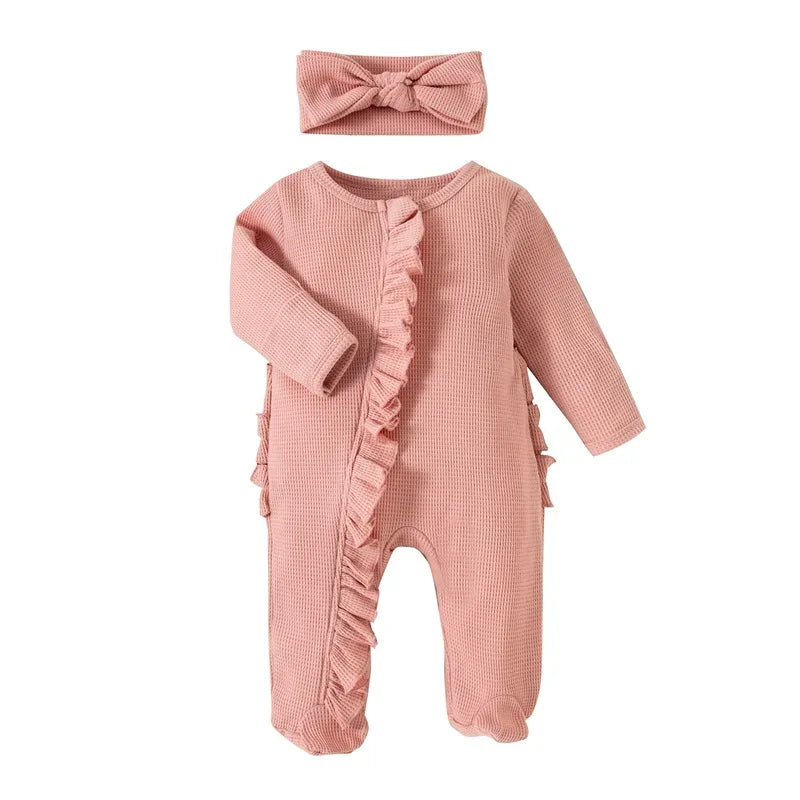 pink ribbed knit baby romper with headbow for newborn girl featuring ruffle detail