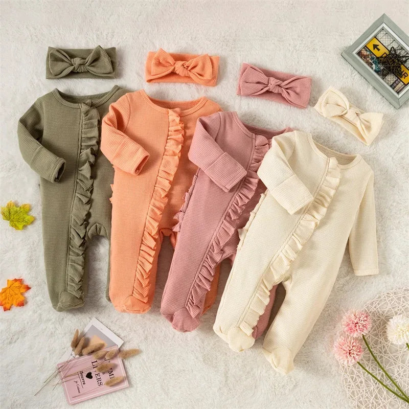 Four ribbed knit baby rompers with headbow in green, peach, pink, and cream for infants displayed flat