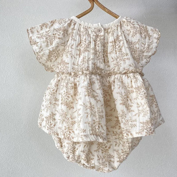 baby cream and beige floral romper with short sleeves and gathered waist for infants