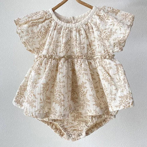 baby cream floral romper with short flutter sleeves and gathered waist detail
