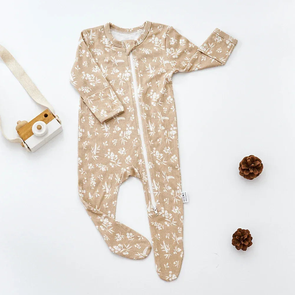 Beige baby romper with white floral print and zipper closure for newborns