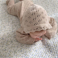 beige knitted baby romper with hood in size for newborns featuring delicate lace trim