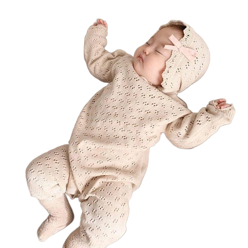 cream-colored knitted baby romper for newborns with matching bonnet and delicate pattern