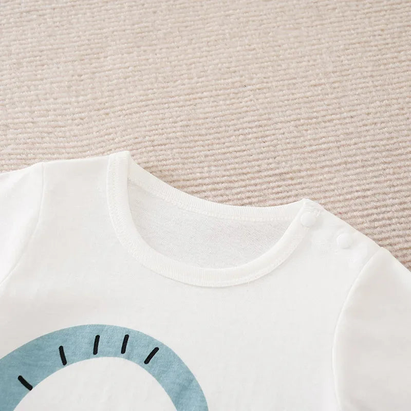 white baby romper jumpsuit with blue semi-circle print and shoulder snap buttons for easy dressing