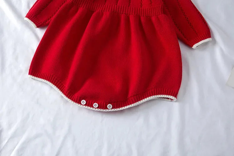 red knitted romper for babies with long sleeves and white trim, size suitable for infants