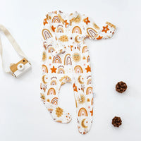 baby romper with white base and orange sun moon stars rainbow print long sleeve footed