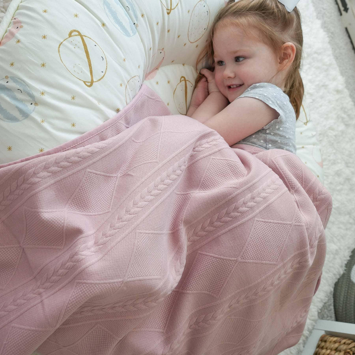 Rose knit baby blanket in soft pink with textured cable knit design for newborns and toddlers