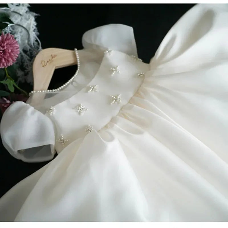White babies special occasion dress with puff sleeves and pearl bead floral details