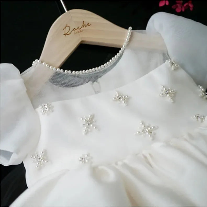 white babies special occasion dress with pearl neckline and puff sleeves