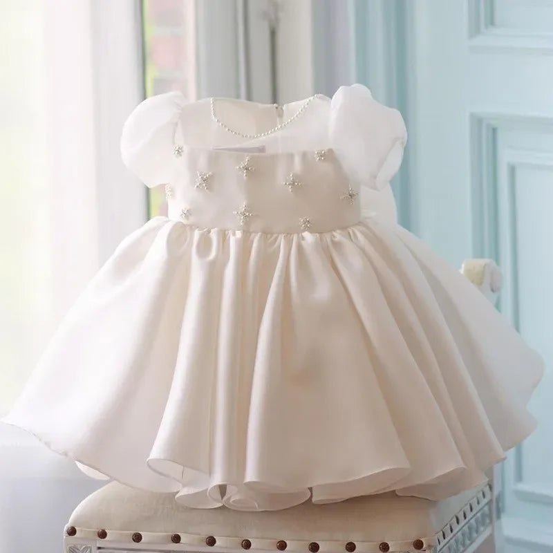 Ivory babies special occasion dress with puff sleeves and pearl star embellishments