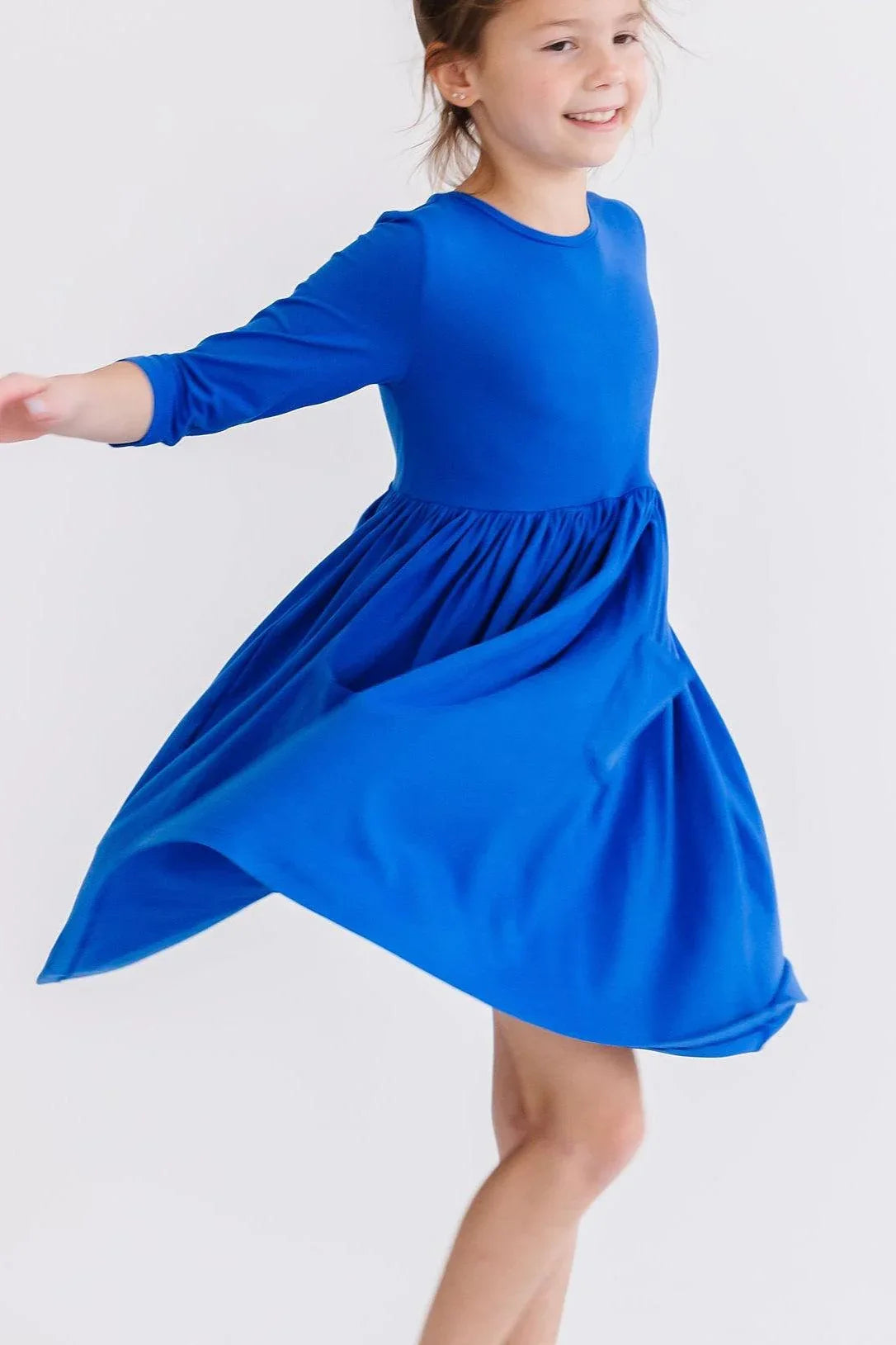 Girls royal blue twirl dress for girls by Mila Rose with 3/4 sleeves and flowing skirt