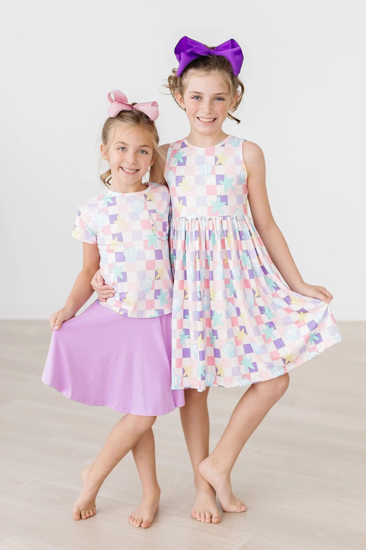 Girls pastel check ruffle pocket tee with short sleeves paired with a lavender skirt, ages 6-8