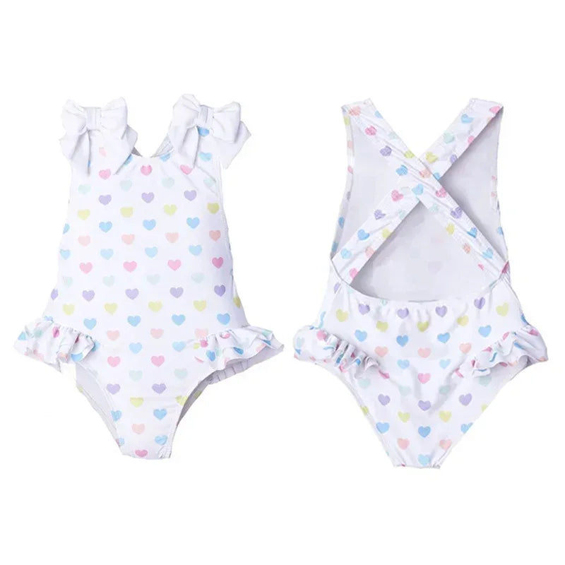 White ruffled heart print toddler swimsuit with pastel hearts and shoulder bows for toddlers