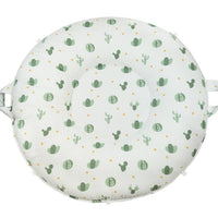 Round sage floor cushion for toddlers with green cactus and watermelon print from Goosewaddle