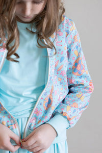 Girls light blue satin jacket with colorful floral print and long sleeves by Mila & Rose