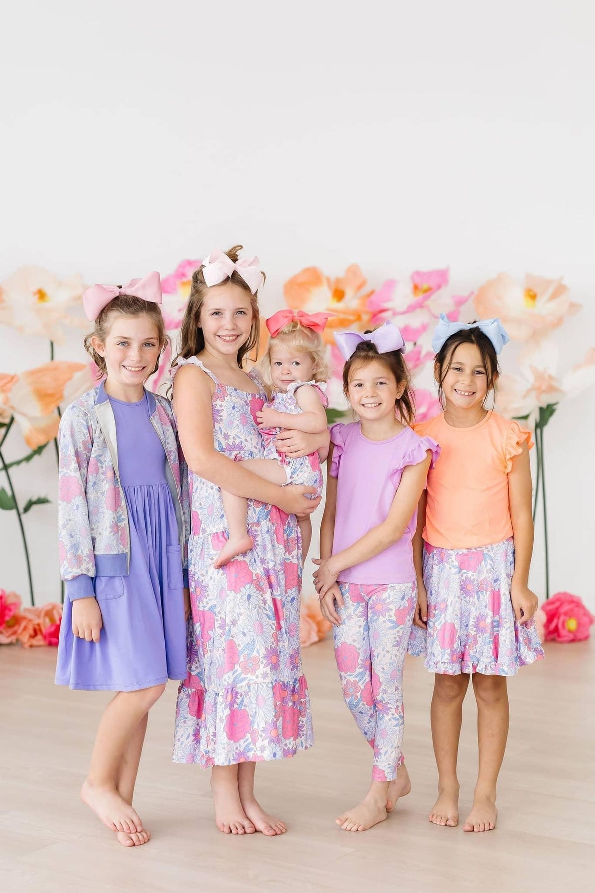 Girls pastel satin jacket with shimmer floral print long sleeve worn by child in group